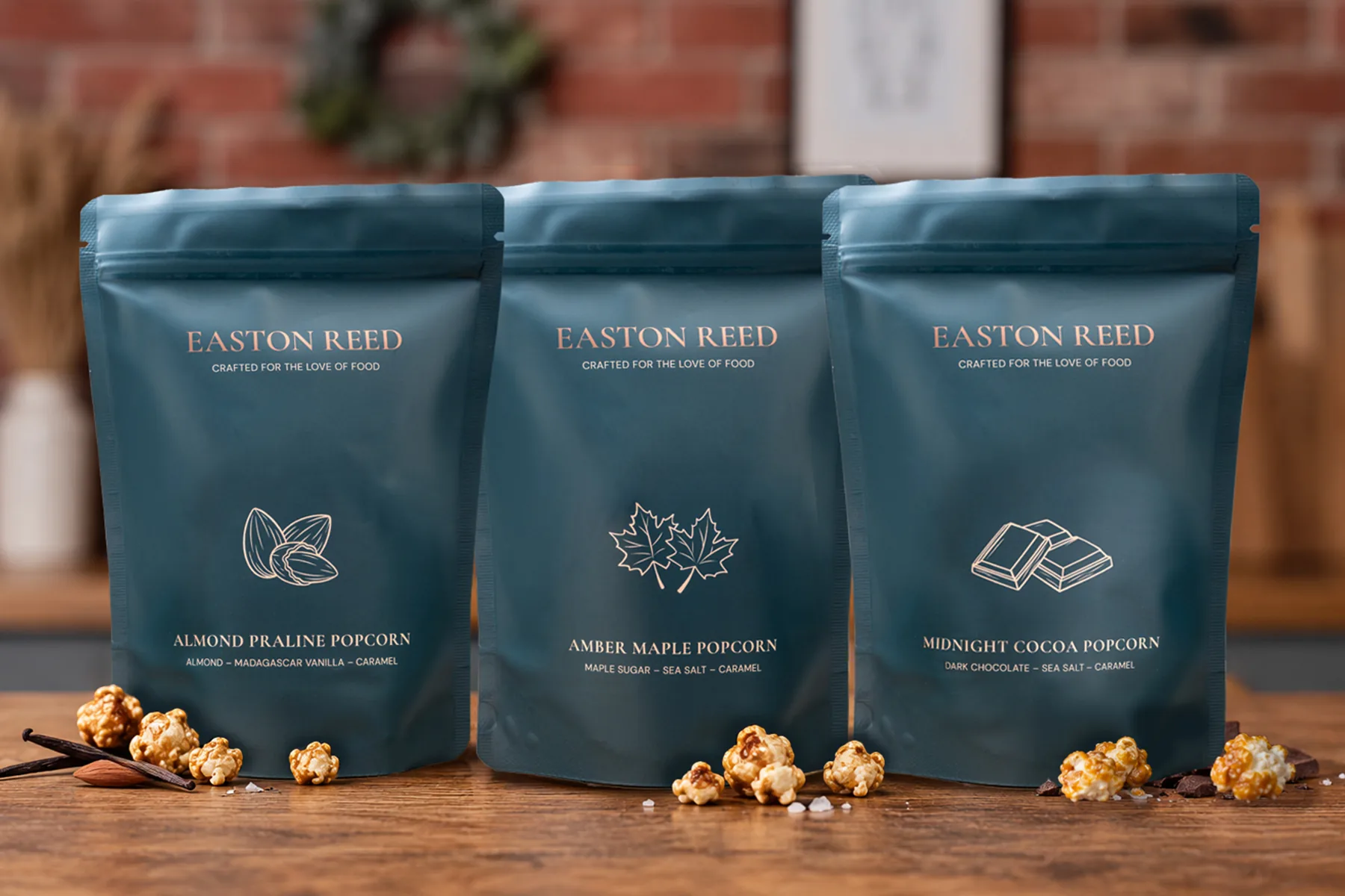 Easton Reed Almond Praline Popcorn bag with shortbread, mallow pralines, sauce and maple syrup on a dining table by the fireplace